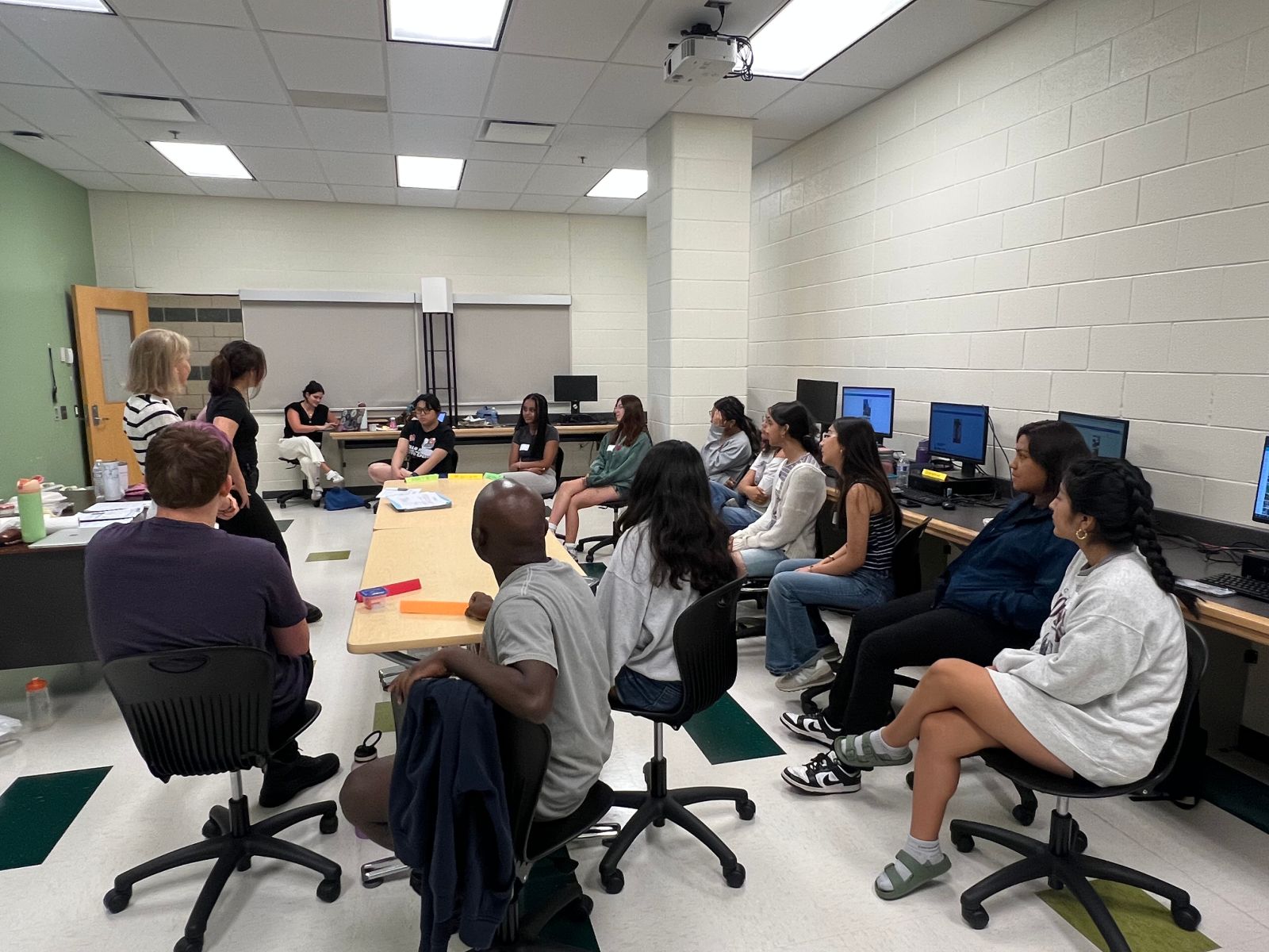 [Leslie and Tiffany lead an IYF workshop with YMG students]